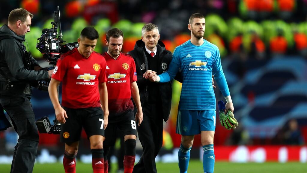 Manchester United manager Ole Gunnar Solskjaer leaves the pitch with David De Gea and team mates after the Champions League Round of 16 defeat to Paris Saint-Germain. Photo: Michael Steele/Getty Images