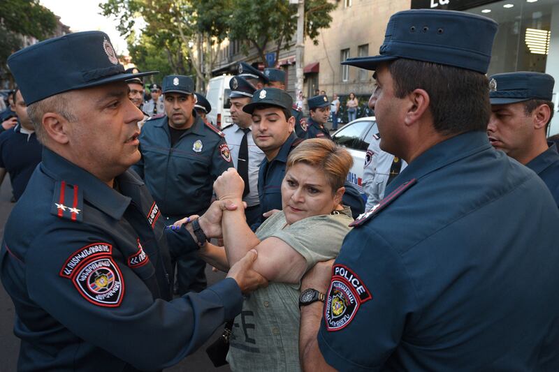 A protester argues with Armenian police officers during a demonstration in Yerevan.Photograph: Karen Minasyan /AFP via Getty Images)