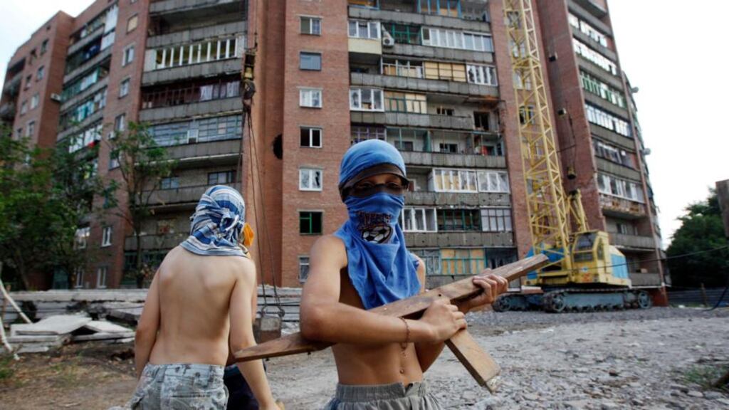 Boys play a game of war between Ukrainian army and pro-Russian separatists in eastern Ukrainian town of Kramatorsk. Photograph: Valentyn Ogirenko/Reuters