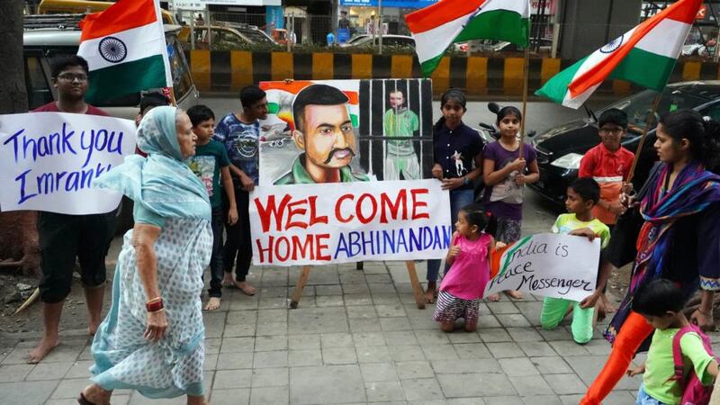 Children stand with a painting of Indian Air Force Wing Commander Abhinandan Varthaman, a day before his release from Pakistan, on February 28th in Mumbai, India. Photograph: Hemanshi Kamani/Hindustan Times/Getty