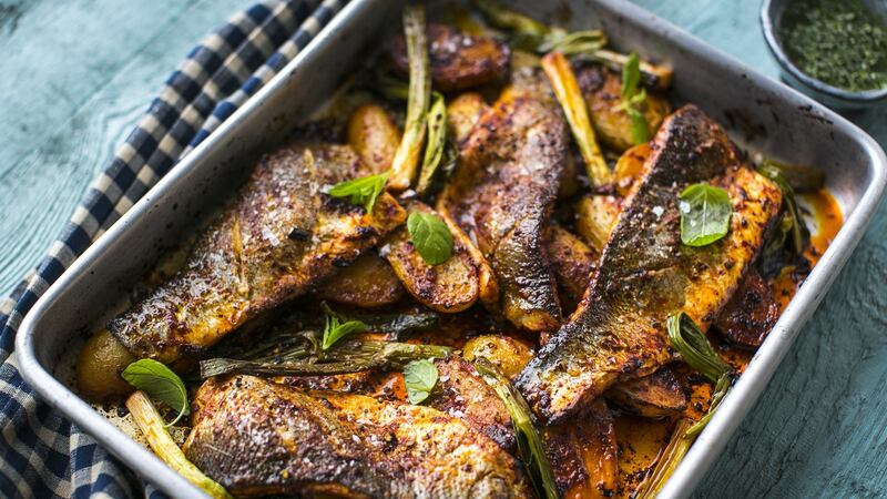 Harissa-baked fish can be cooked with potatoes in the oven.