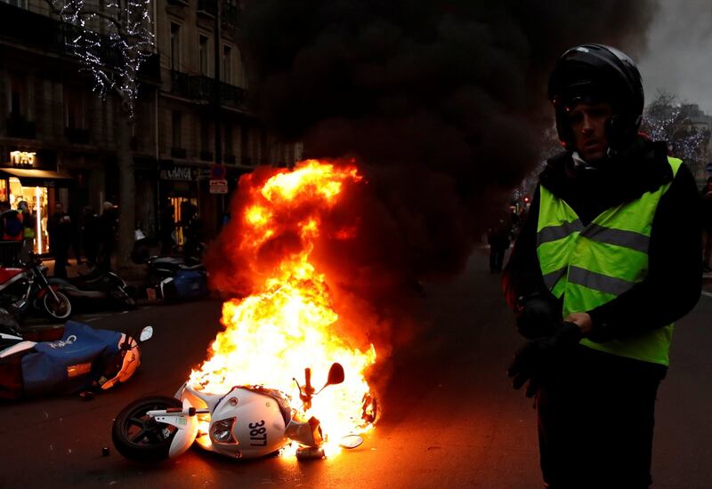 A motorcycle burns during a demonstration by the yellow vest movement at Boulevard Saint Germain in Paris on January 5th Photograph: Gonzalo Fuentes/Reuters