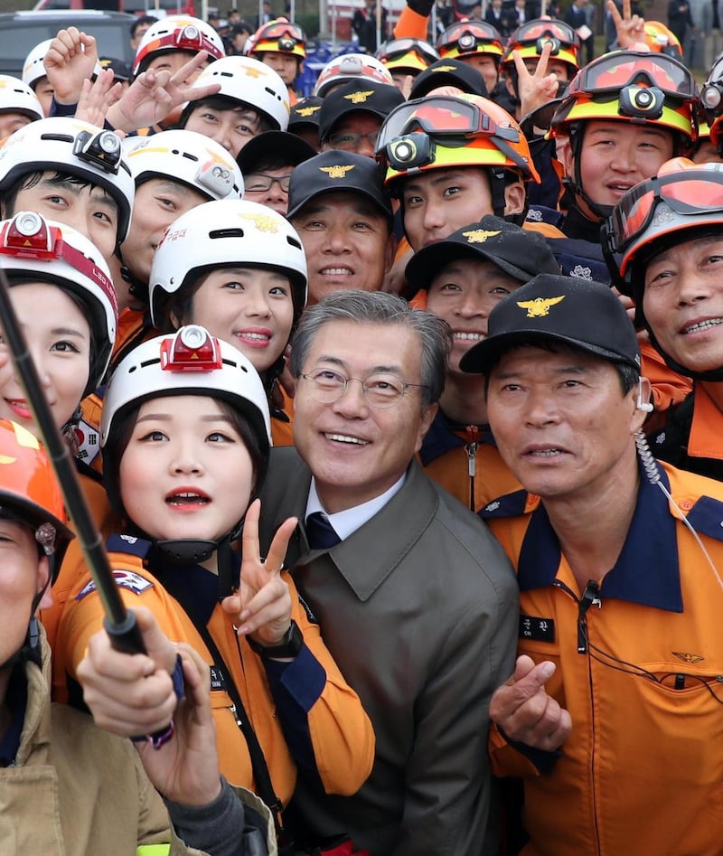 South Korean president Moon Jae-in poses for a selfie with firefighters at an event to celebrate Firefighters Day in Cheonan, South Korea, on Friday. Photograph: Yonhap/EPA
