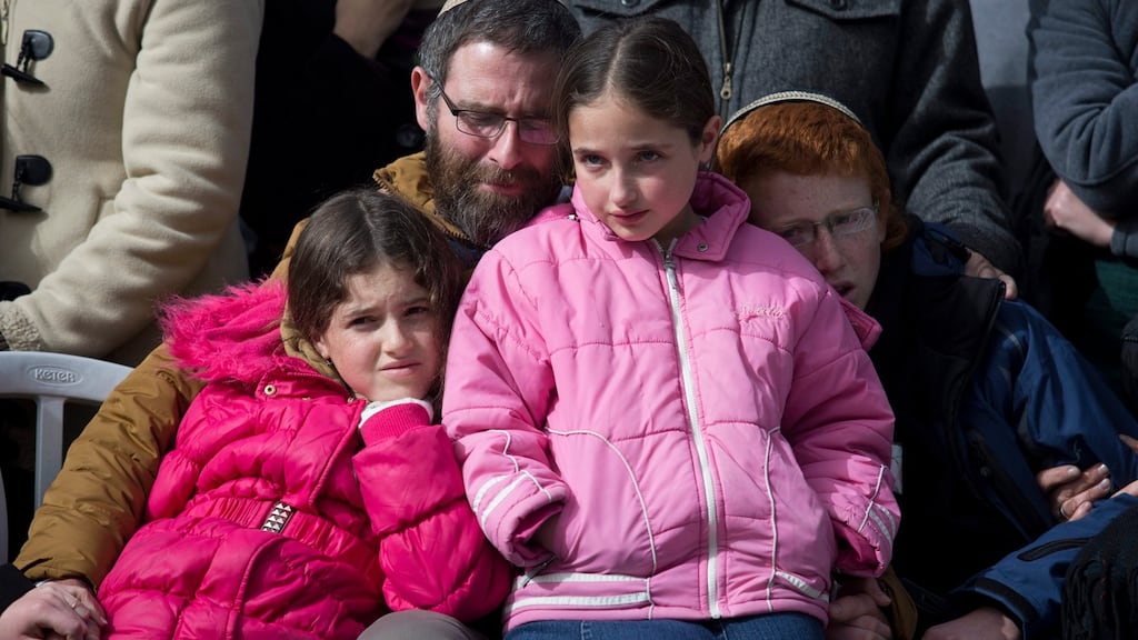 Natan Meir, the husband of Israeli woman Dafna Meir who was killed when she opened the door of her home in the settlement of Otniel on Sunday, at her funeral in Jerusalem. Photograph: Abir Sultan/EPA