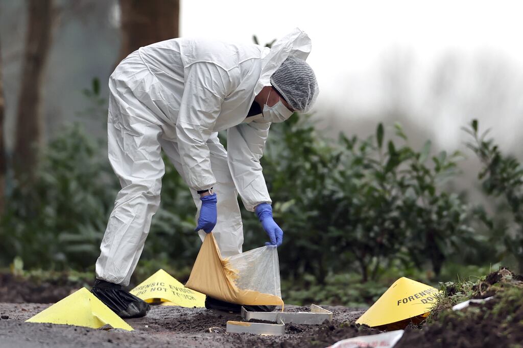 A forensic officer at the scene near the sports complex in the Killyclogher Road area of Omagh where off-duty PSNI detective John Caldwell was shot. Photograph: PA Wire