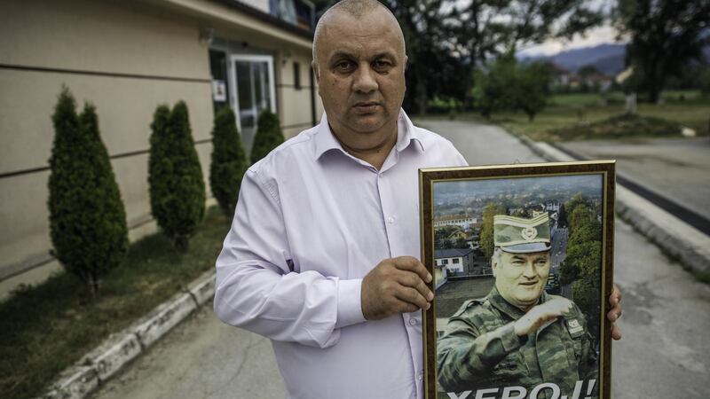 Vojin Pavlovic, an organiser of the “Srebrenica liberation day” event poses with a photo of convicted war criminal Ratko Mladic with a word “hero” written on it onin Bratunac, near Srebrenica. Photograph: Damir Sagolj/Getty Images