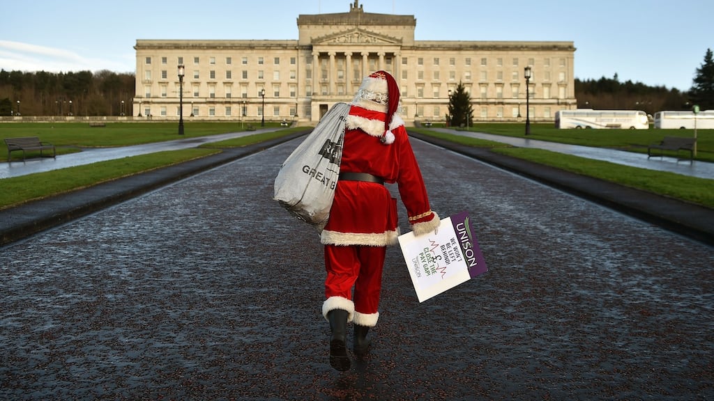 A protestor dressed as Santa Claus walks towards Stormont government. Photograph: Charles McQuillan/Getty Images