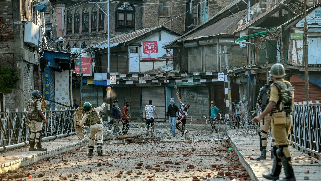 Protesters throw rocks in the streets of Srinagar following Indian prime minister Narendra Modi’s decision to revoke Kashmir’s autonomy. Photograph: Atul Loke/New York Times