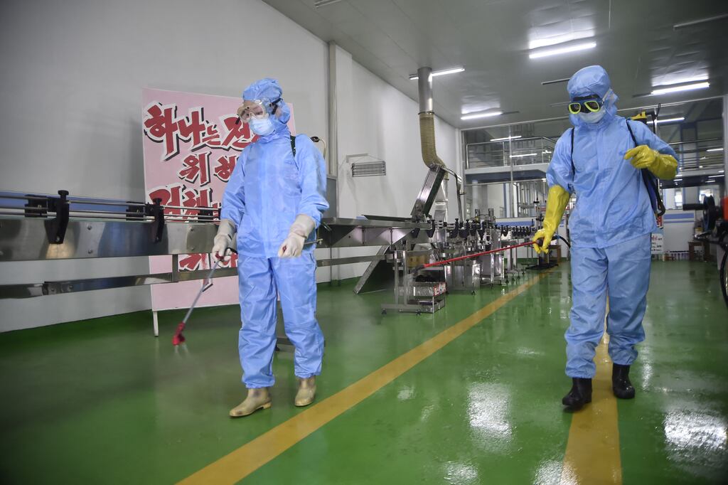 Health officials disinfect the floor of work place inside the Ryongaksan soap factory in Pyongyang. Photograph: Kim Won Jin/AFP via Getty Images