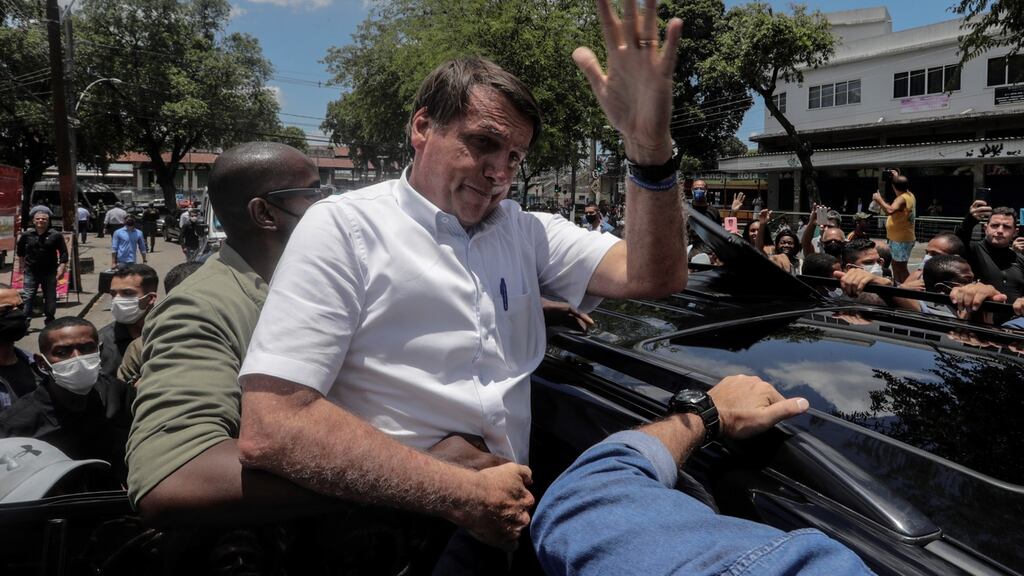 Brazilian president Jair Bolsonaro greets supporters after voting in Rio de Janeiro. Photograph: Antonio Lacerda/EPA