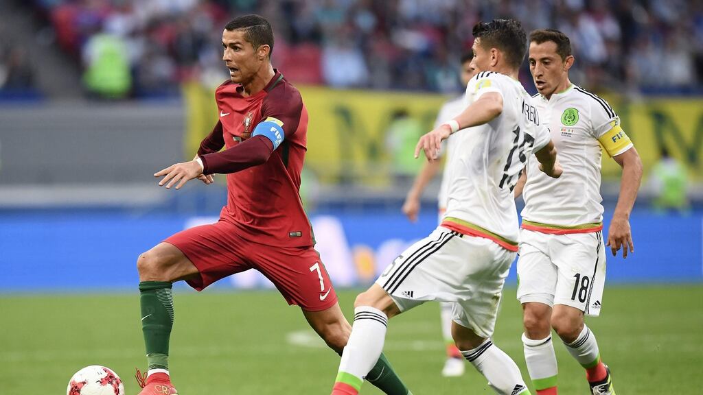 Portugal’s forward Cristiano Ronaldo vies with Mexico’s defender Hector Moreno  during the  Confederations Cup  match in Kazan on Sunday. Photograph: Franck Fife/AFP/Getty Images