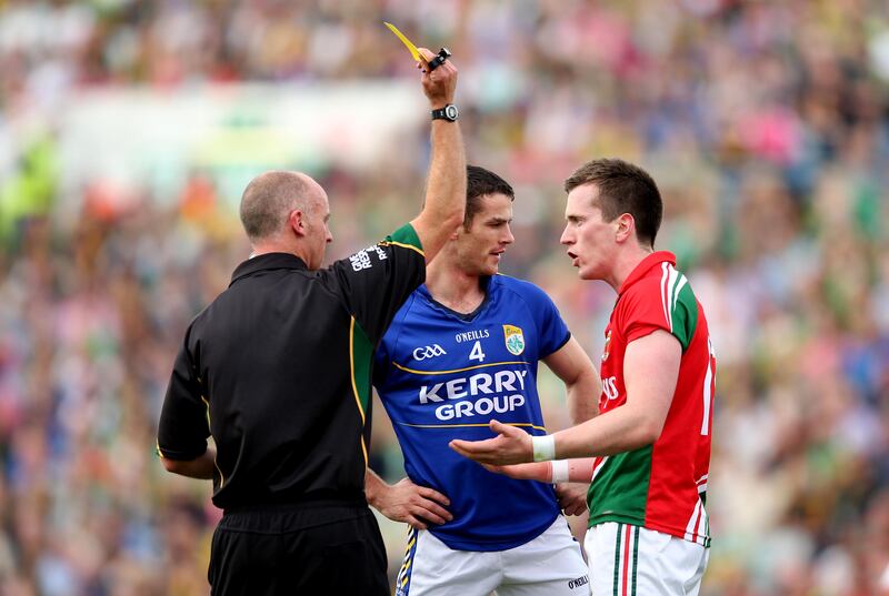 Cormac Reilly yellow cards Kerry’s Shane Enright and Cillian O'Connor of Mayo. Photograph: James Crombie