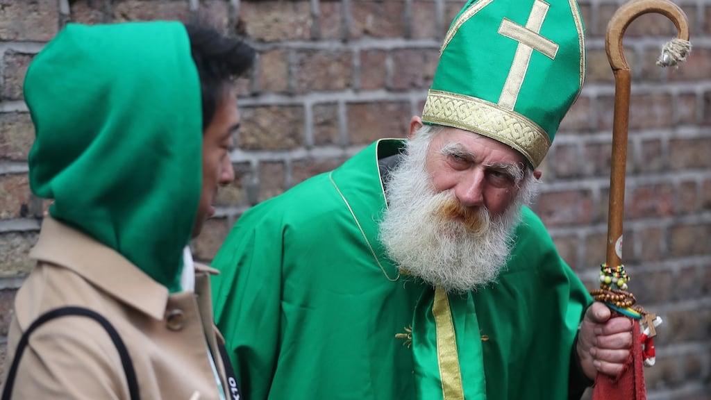 A Japanese tourist chats with a busker dressed as St Patrick in Temple Bar as Dublin’s St Patrick’s Day Festival begins. Photograph: Niall Carson/PA