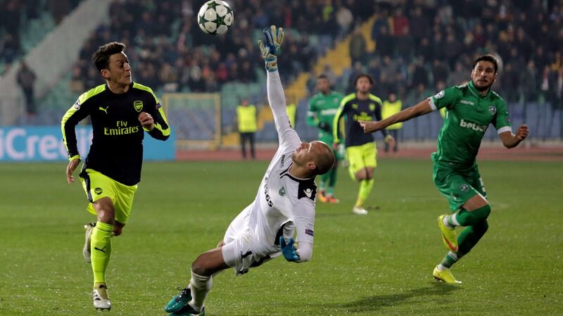 Arsenal’s Mesut Ozil, left, scores during the Champions League game in Sofia, Bulgaria. Photograph: AP Photo/Valentina Petrova