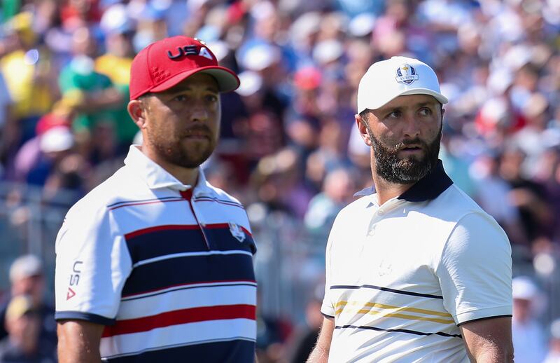 USA's Xander Schauffele (left) and Europe's Jon Rahm look on from the first tee during Sunday's singles matches. Photograph: Andrew Redington/Getty Images