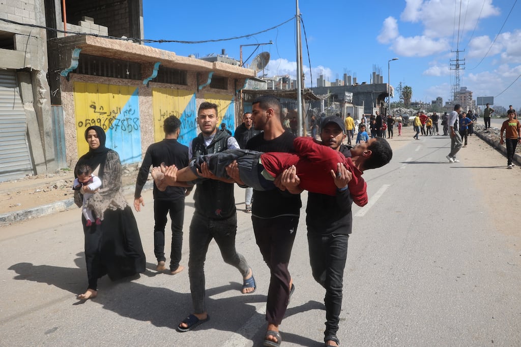 Palestinians carry a man for medical treatment after Israel resumed air strikes on Gaza following a ceasefire breakdown. Photograph: Eyad Baba/Getty