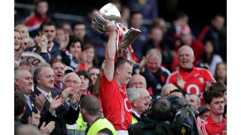 Cork's Michael Shields gets his hands on the league trophy after the final win over Mayo in April. Photograph: Morgan Treacy/Inpho