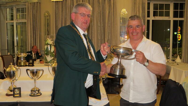 Irish Trout Fly Fishing Association president Ger Lenihan presents the winning team trophy to Leinster captain Fran Nugent