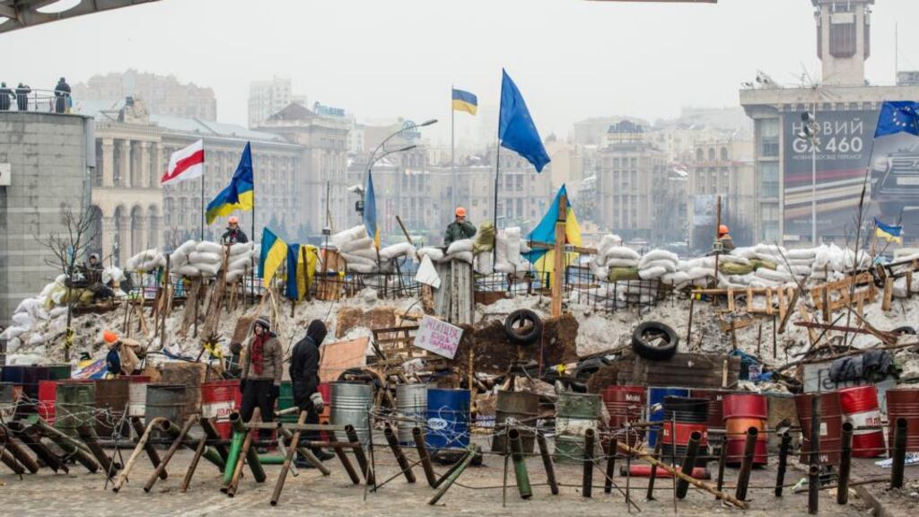 Anti-government protesters continue to fortify their barricades to block the police from forcing them out of Independence Square in Kiev yesterday. Photograph: Brendan Hoffman/Getty Images