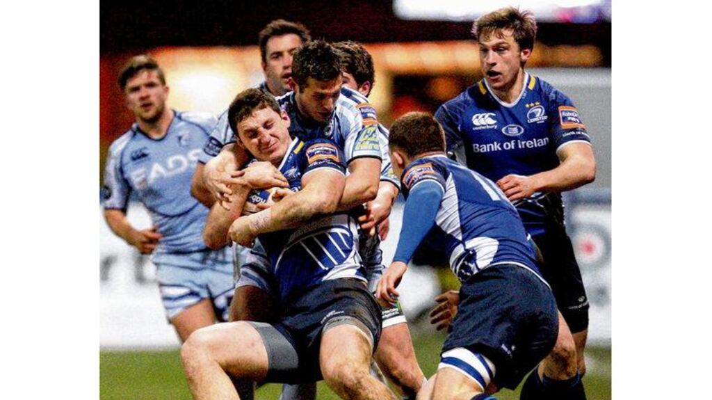 Leinster's Darren Hudson is held by Cardiff Blues' Jason Tovey during last night's clash at Cardiff Arms Park. photograph: huw evans/inpho