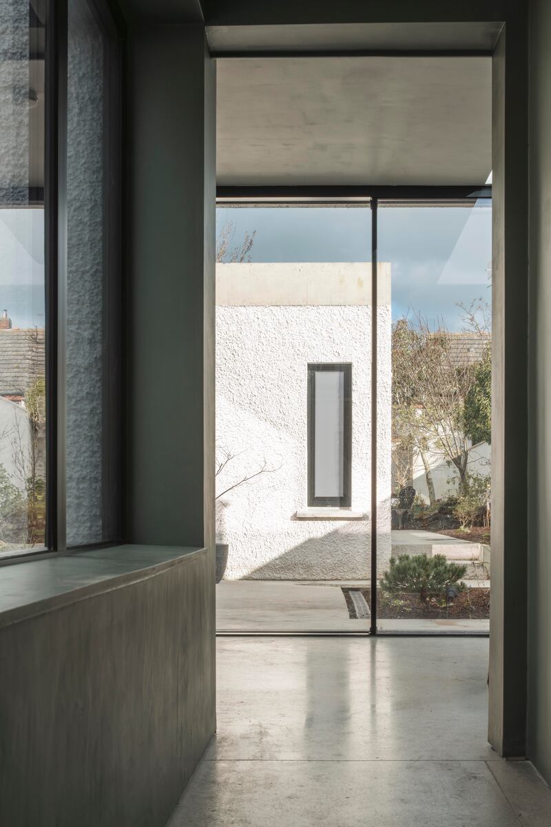 The new extension wraps around the two courtyards, housing the utility, kitchen-dining area and the main bedroom. Photograph: Fionn McCann