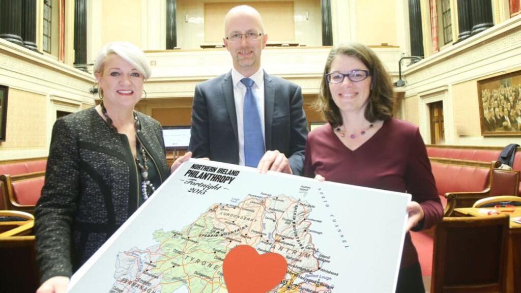 Sandara Kelso-Robb, strategic adviser of Giving Northern Ireland, and Dr Gareth McGrath, director of Politics Plus, greet Prof Angela Eikenberry, Fulbright scholar at the University of Birmingham, who gave a special lecture on the meaning and impact of philanthropy at Parliament Buildings as part of Philanthropy Fortnight. Photograph: Paul Moane / Aurora