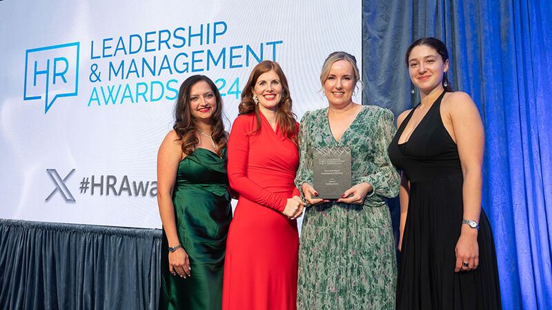 Miriam Manning, awards judge, presents the best learning and development strategy award to the Depaul team