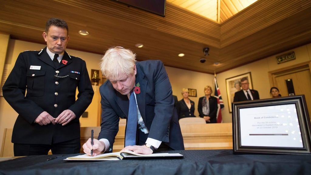 British  prime minister Boris Johnson signs a book of condolence for the 39 people who died in a trailer. Photograph: Getty