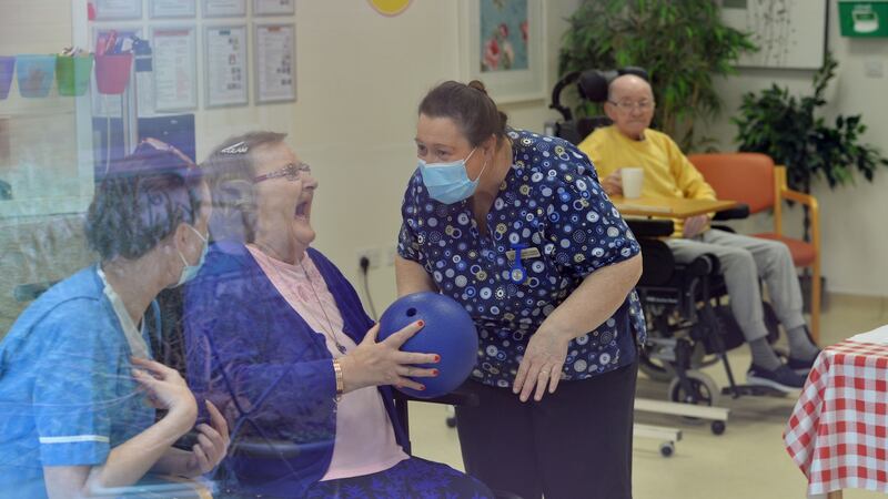 Laundry attendant Jennifer O’Connor, resident Mary Molloy and healthcare assistant Alison Fitzgerald: ‘You were fearful for the residents, you were fearing for yourself, and the other staff. You were exhausted by the end of the day,’ says Fitzgerald. Photograph: Alan Betson/The Irish Times