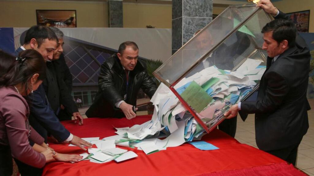 A member of a local electoral commission empties a ballot box after a parliamentary election at a polling station in the Tajik capital Dushanbe. Photograph: Nozim Kalandarov/Reuters