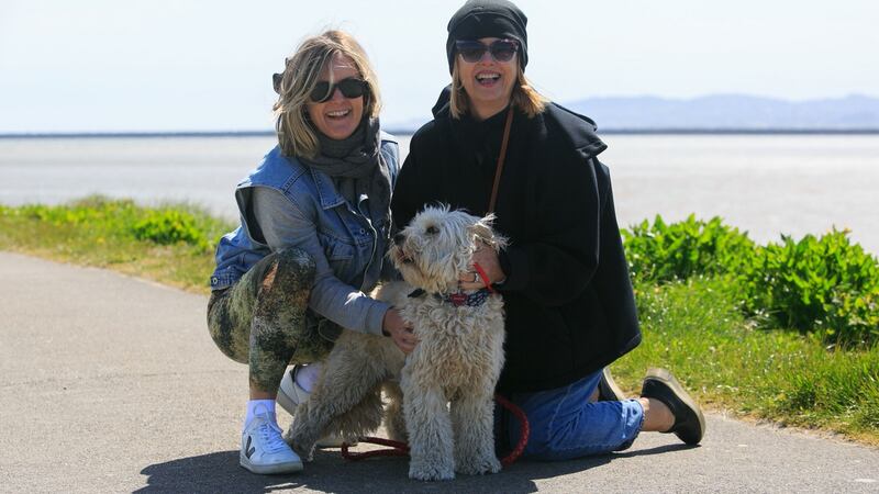 Sarah Shannon (left) and Margo Shannon from Clonskeagh with Millie, a cockapoo, enjoying the good weather at Dollymount Beach, Dublin. Photograph: Collins