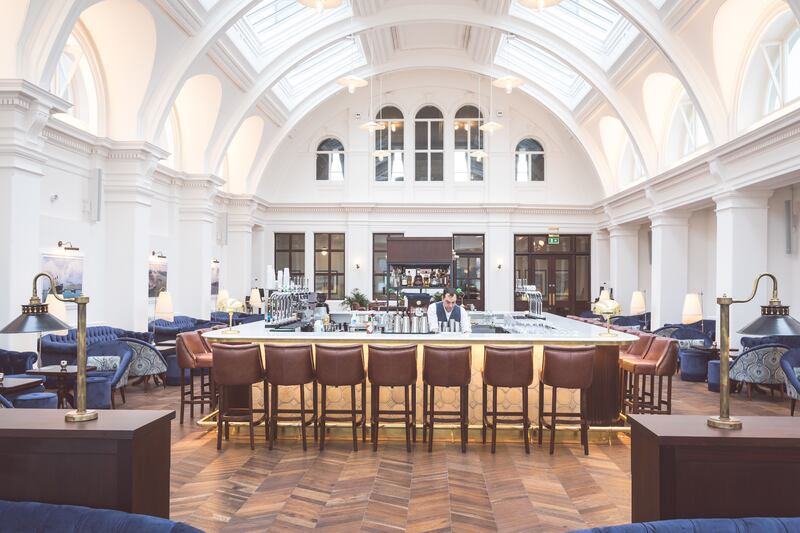 Sip a cocktail in the elegant Harland Bar, at the Titanic Hotel, Belfast. Photograph: Christopher Heaney