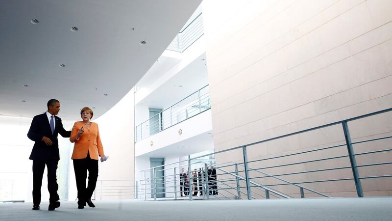 US president Barack Obama and German chancellor Angela Merkel making their way to a news conference at the Chancellery in Berlin in June. Mr Obama knew since 2010 his intelligence service was eavesdropping on German leader Angela Merkel and even asked for more data on her, a newspaper reported today. Photograph: Thomas Peter/Reuters