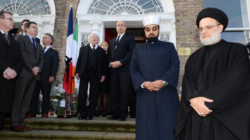 The scene during the minute’s silence at the French Embassy in Dublin where the Presient Micheal D Higgins and his wife Sabina were among the crowd gathered to honour those who died and were injured in the Paris attacks. Photograph: Cyril Byrne
