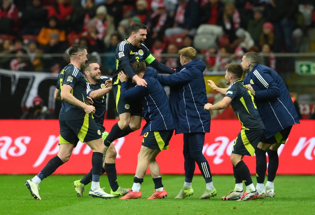 Andy Robertson celebrates with his Scotland team-mates after scoring the winning goal in the Nations League match against Poland at the National Stadium in Warsaw. Photograph: Adam Nurkiewicz/Getty Images