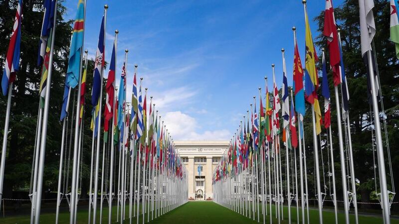 The Flag-draped entrance to the United Nations building in Geneva, Switzerland.