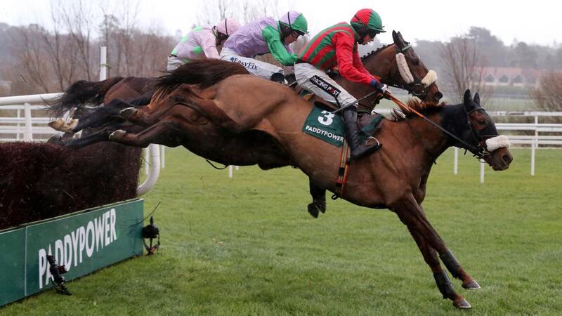 Bryan Cooper pops Benefficient (foreground) over the last before going on to win the Dial-A-Bet Chase at Leopardstown. Photograph: Cathal Noonan/Inpho