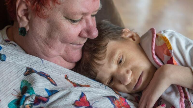 Johanne holds Siobhan who cannot walk, is non-verbal, does not eat solid food, is doubly incontinent, and has only one kidney. Photograph: Brenda Fitzsimons