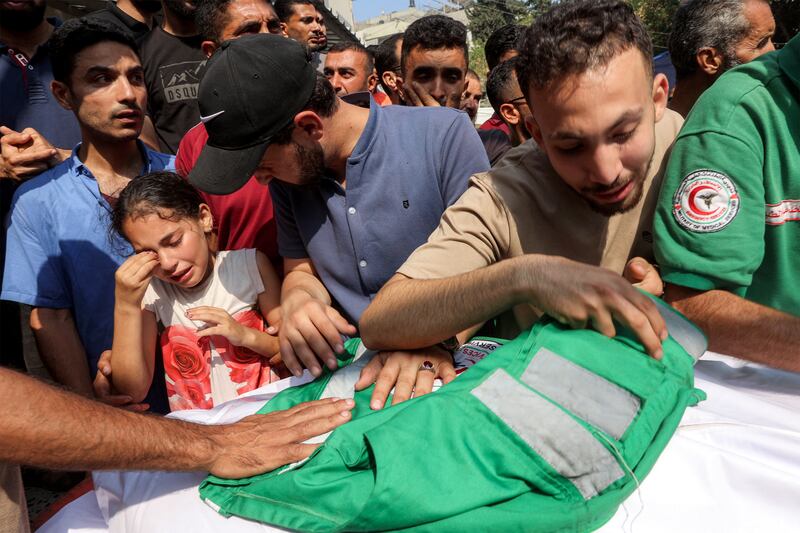 Mourners at the funeral of three paramedics killed by Israeli bombardment on Tuffah, Gaza of Gaza. Photograph: Omar Al-Qattaa/AFP/Getty Images