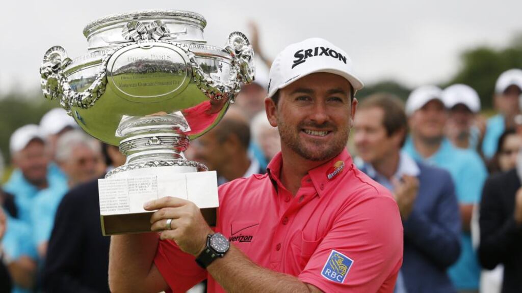 Northern Irishman golfer Graeme McDowell poses with his trophy after winning the 2014 Alstom Open de France on. Photo: Thomas Sampson/Getty Images