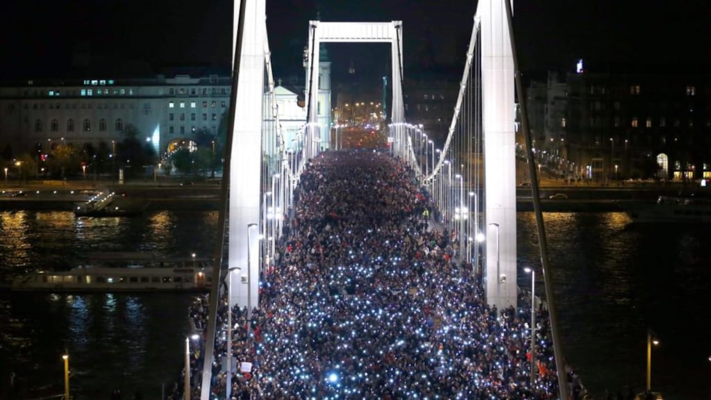 ‘By Friday, reckoning discretion to be the better part of valour, Orbán abandoned the new tax altogether. People power.’ Above, earlier in the week tens of thousands of Hungarians held up their mobile phones as they crossed the Elisabeth Bridge, in Budapest, during a protest against the tax on internet data transfers. Photograph: Laszlo Balogh/Reuters