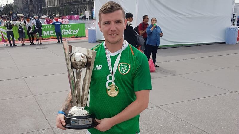 Danny Moore with the Tier 3 trophy after scoring a goal in the final
