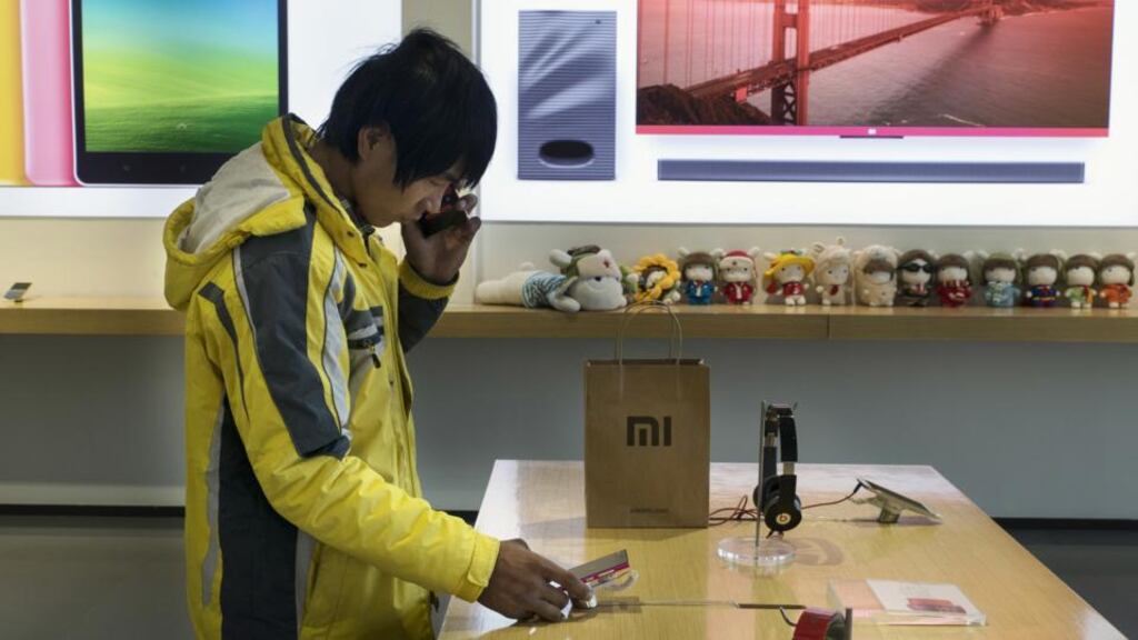 Checking out Xiaomi phones in Beijing. photograph: gilles sabrie/the new york times