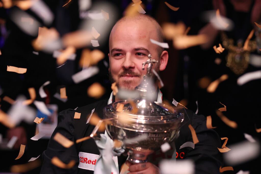 Luca Brecel celebrates with the World Snooker Championship trophy at the Crucible on Monday night. Photograph: George Wood/Getty Images