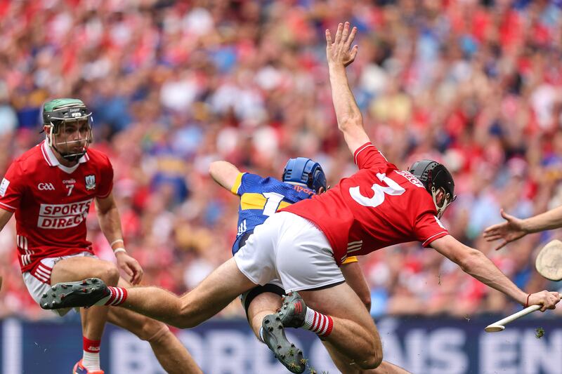 Cork's Eoin Downey tackles John McGrath of Tipperary. Photograph: Inpho