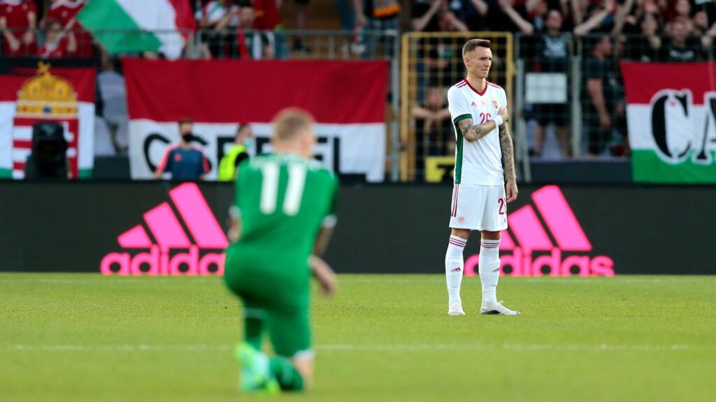 Hungary’s Bendeguz Bolla stands while the Republic of Ireland’s James McClean takes a knee at Szusza Ferenc Stadium, in Budapest. Photograph: Trenka Atilla/PA