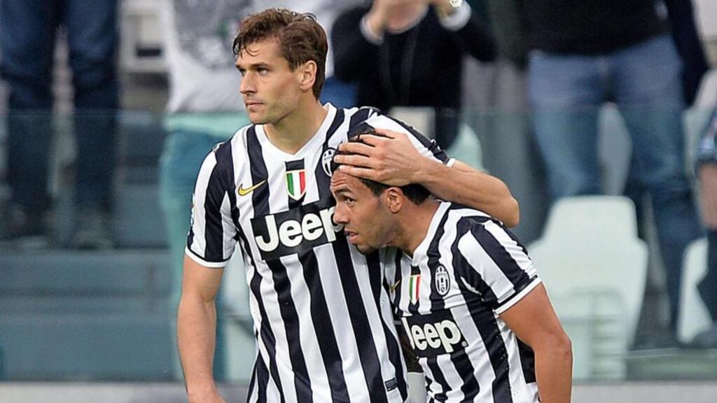 Juventus’ Fernando Llorente (left) celebrates with teammate Carlos Tevez after scoring against AS Livorno. Photograph: Alessandro Di Marco / EPA