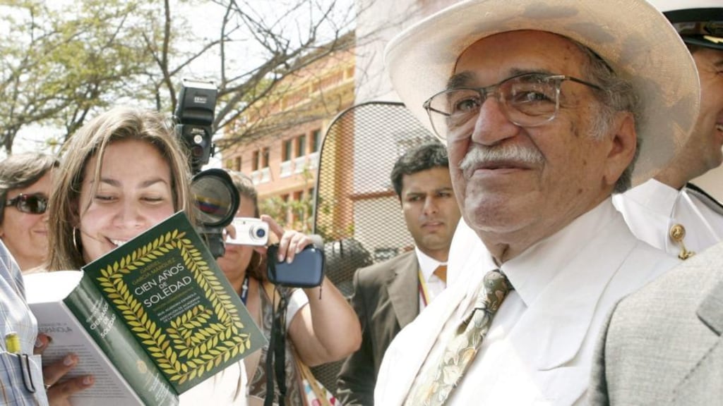 2007: Garcia Marquez poses with a special edition of his most famous book ‘One Hundred Years of Solitude’ in Cartagena de Indias, Colombia.