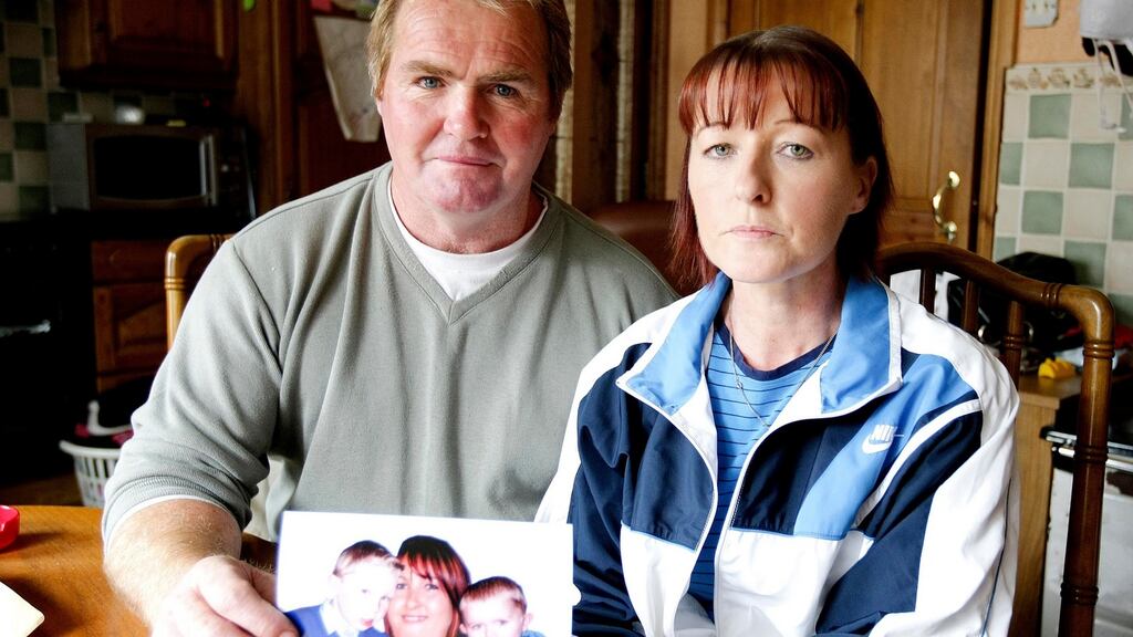 John and Una Kelly holding a photograph of their daughter Edel and grandchildren Jack and Lee at their home in Kilrush Co Clare. Photograph:  Press22.