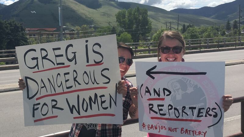 Two women in Missoula, Montana, hold up signs as people vote in a special congressional election on Thursday. The winning candidate, Republican Greg Gianforte, has been charged with assaulting a reporter. Photograph: Ivan Couronne/AFP/Getty Images